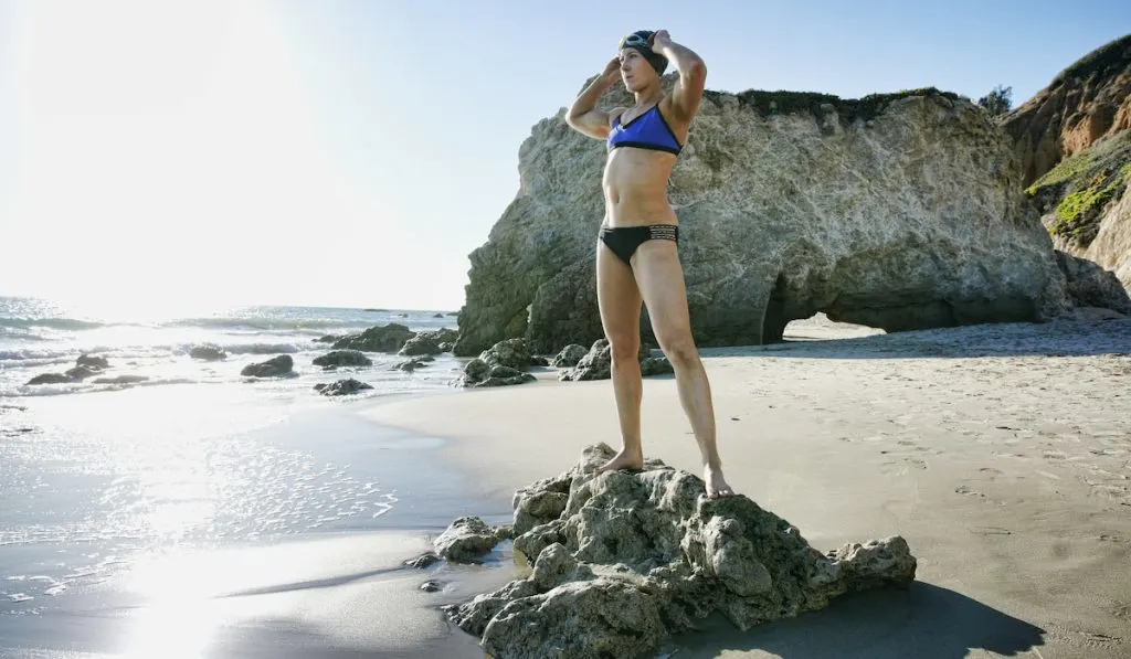 triathlete standing on top of rocks