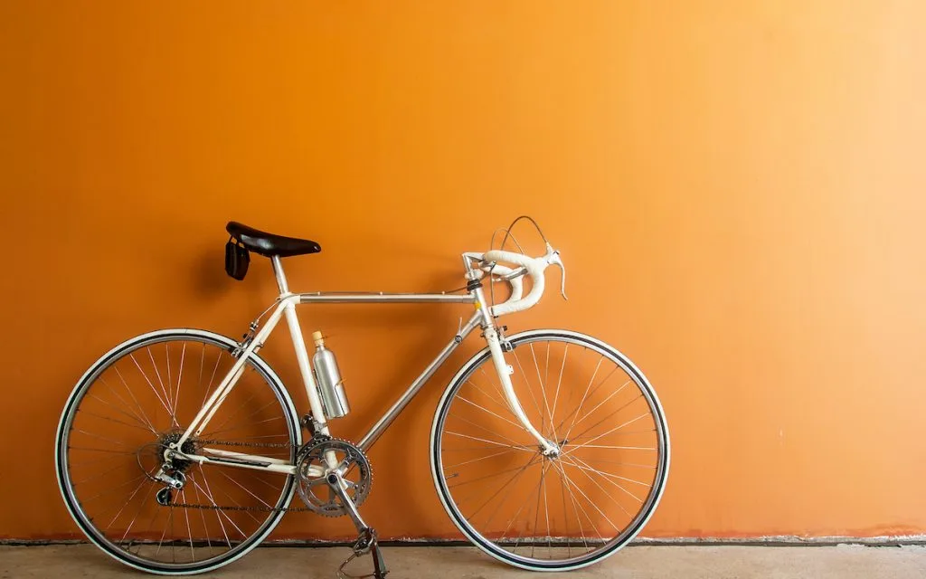 hybrid bike on orange colored wall
