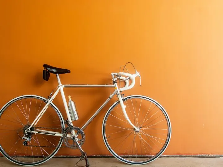 hybrid bike on orange colored wall