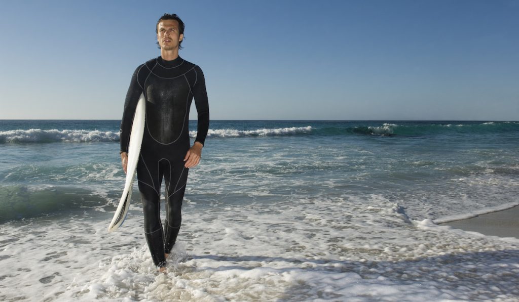 man wearing surfing wet suit