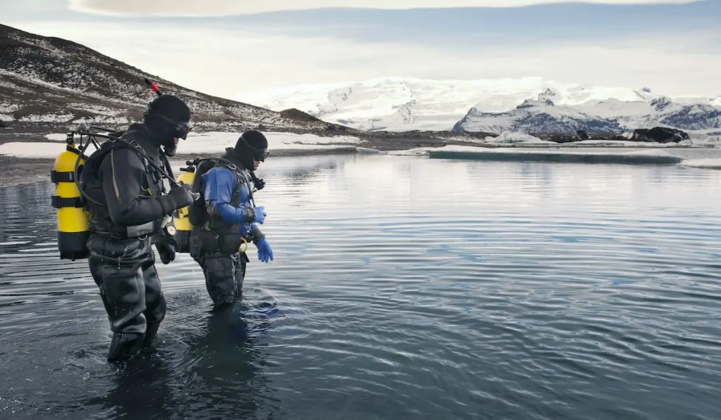 scuba divers ready to take on cold waters