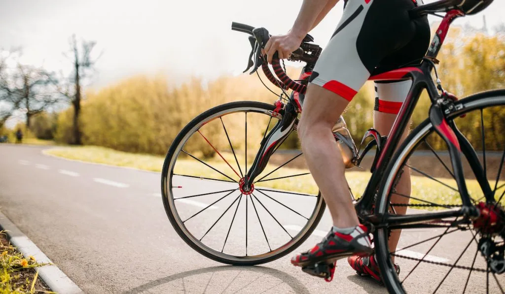 Bycyclist in helmet and sportswear on bike workout 