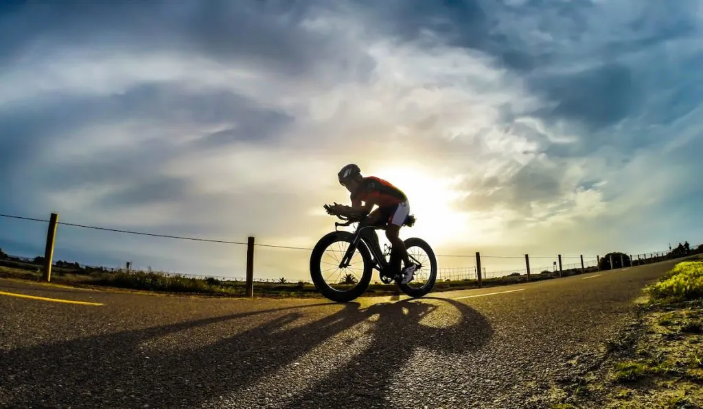 Cyclist biking during sunset