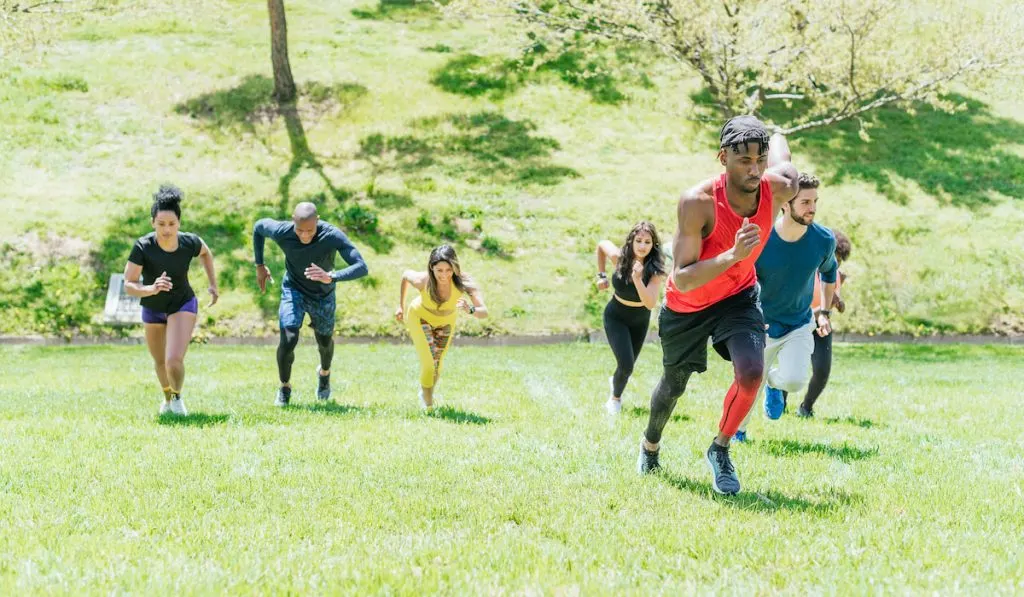 Group of runners running up a hill 