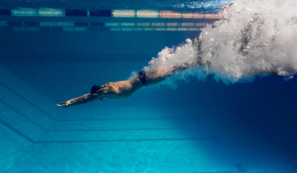 underwater picture of male swimmer swimming in swimming pool 
