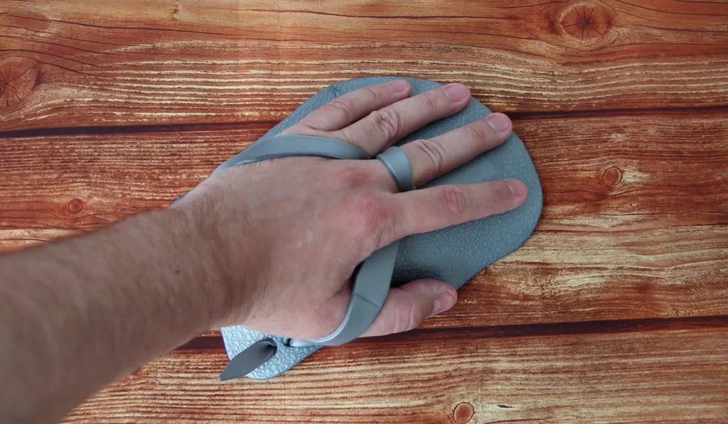 hand swimming paddle on wooden background 