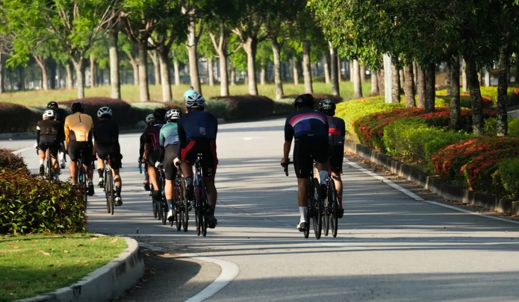 A group of cyclist cycling in town
