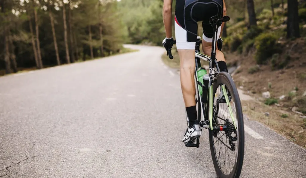 Cropped photo of a Cyclist riding a racing cycle on a road