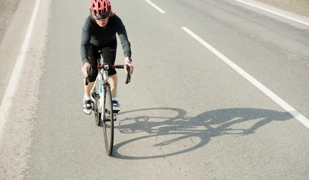 Female sportsman cyclist riding racing bicycle
