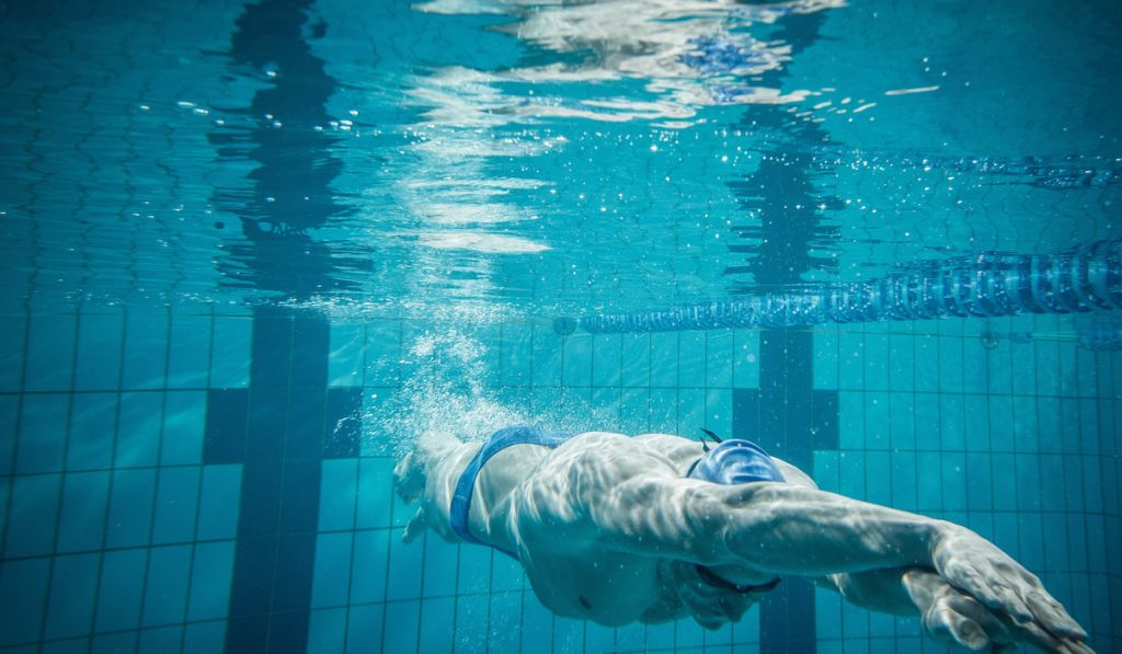 Swimmer under water in swimming pool
