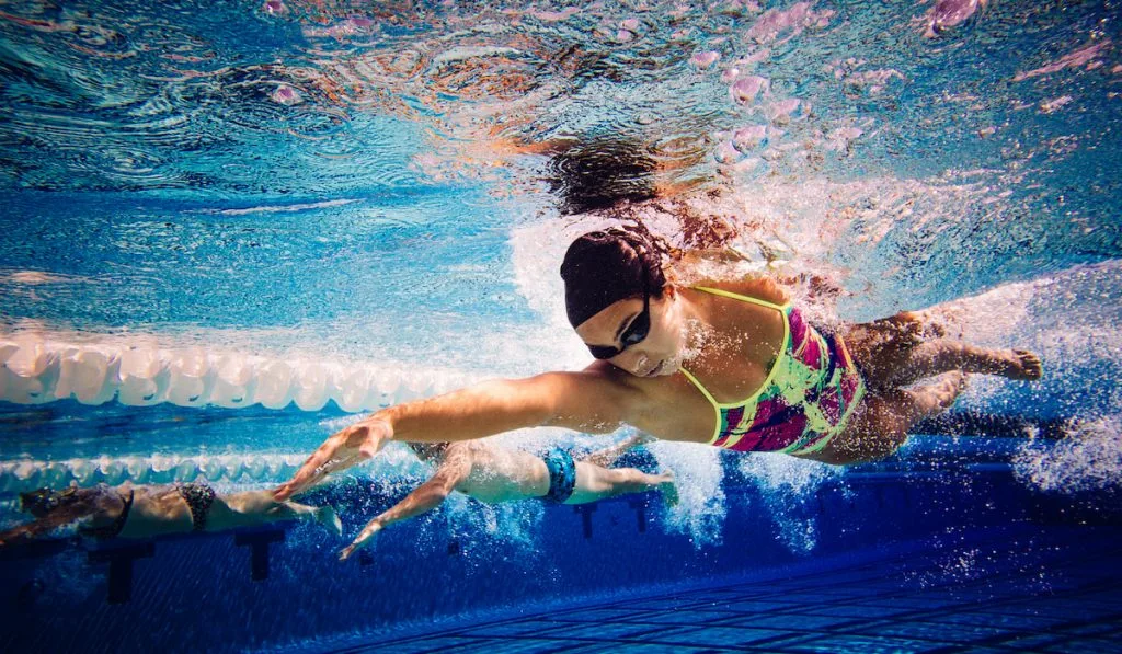 Swimmers doing freestyle in lane