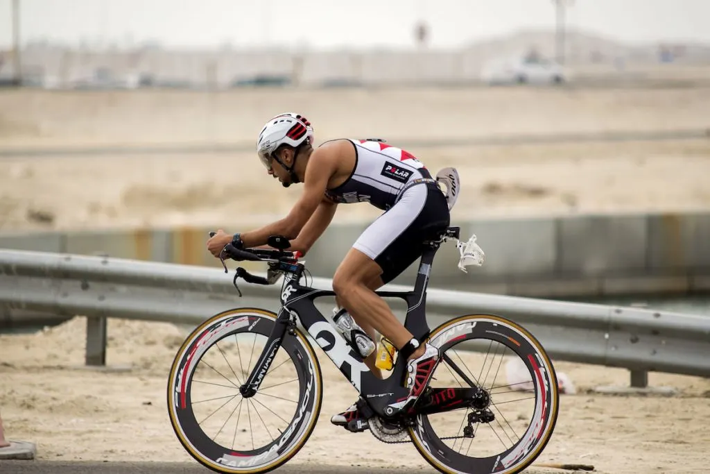 Triathlete-riding-his-triathlon-bike-with-aero-bars