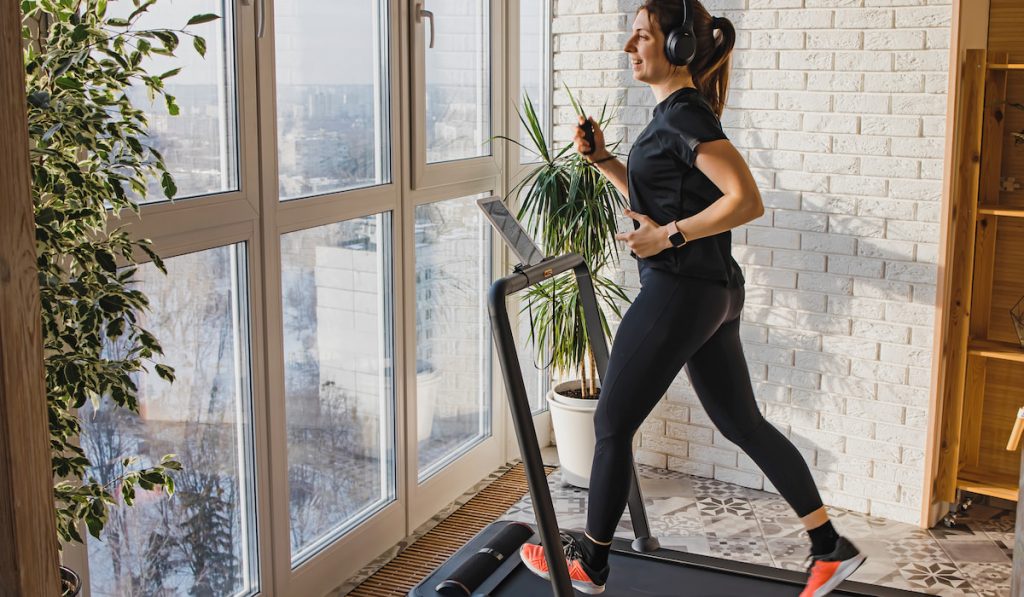 Woman running on treadmill at home